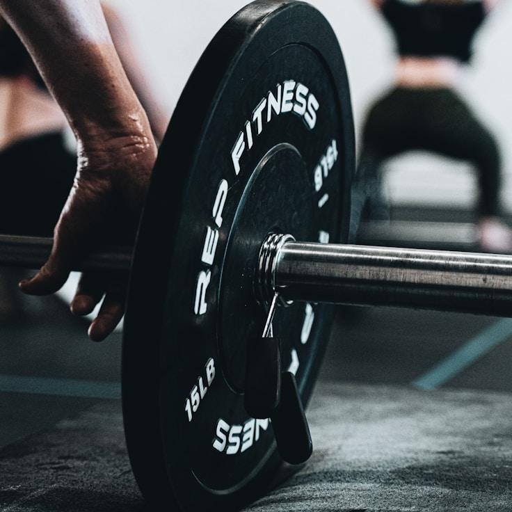 Interior of a professional gym with weight training equipment and mirrors